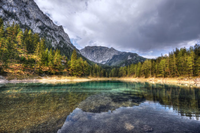 Green Lake in Styria Austria.European Alps. dark clouds reflection in the mountain lake.