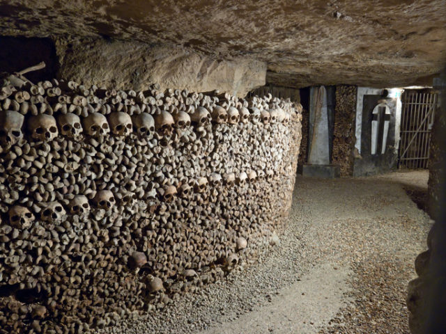 “In 1785, Paris decided to solve the problem of its overflowing cemeteries by exhuming the bones of the buried and relocating them to the tunnels of several disused quarries, which were consecrated as a cemetery. It is estimated that about one million bodies are buried here. Paris, France.”