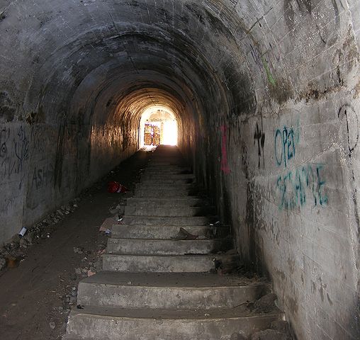 Tunnel inside Illowra Battery with tracks for carts to haul munitions to the gun emplacements. Author Adam.J.W.C. CC BY 3.0