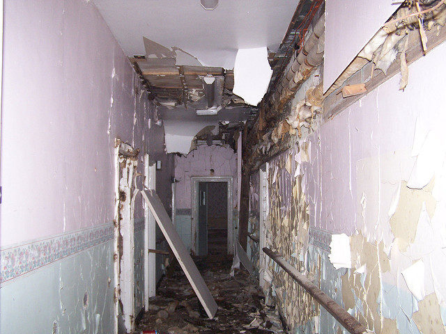 The decaying corridor of the isolation ward. Photo Credit