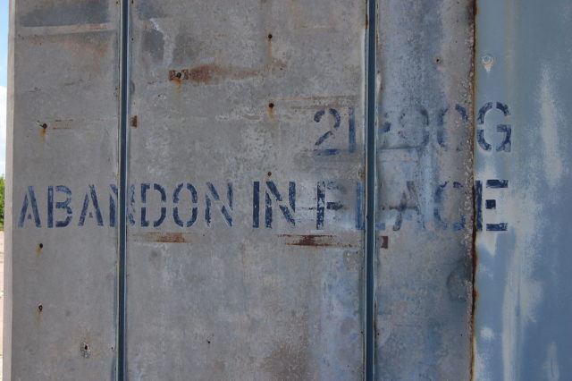 “Abandon in place” graffiti at Launch Complex 34, meaning to abandon it “as is”, with no maintenance – Author: Bubba73 – CC BY-SA 3.0