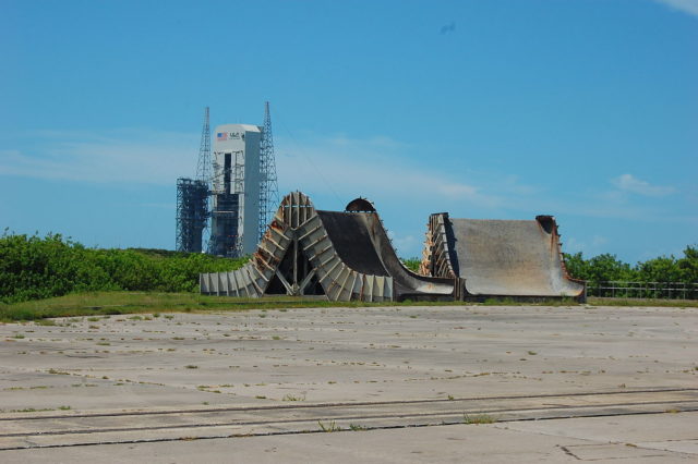 Abandoned Saturn I and IB flame deflectors. Pad 37 is in the background. – Author: Bubba73 – CC BY-SA 3.0