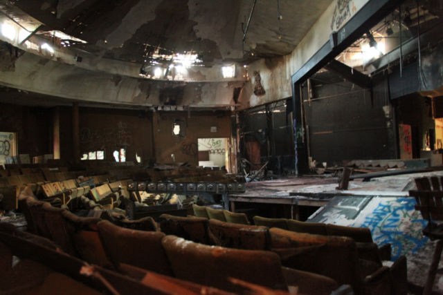 The abandoned community theater is one of the few buildings that remain on the peninsula (shown here as it stands August 2012.). Author: Lastchance1291. CC BY-SA 3.0