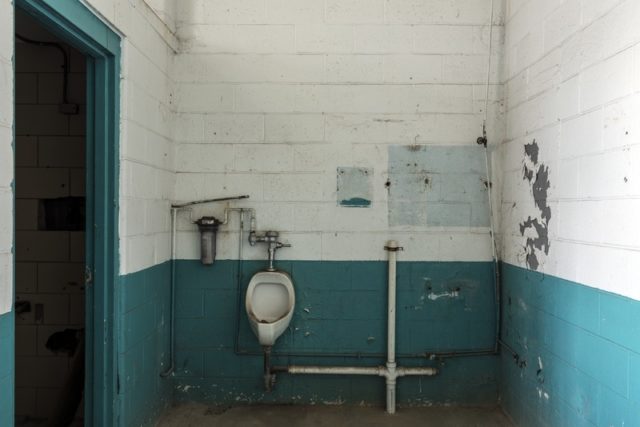 Urinal and crude pipe fixtures.