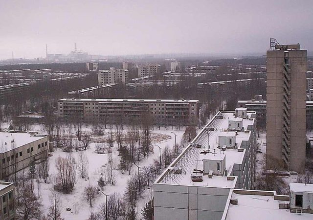 The city of Pripyat and the Chernobyl facility in the distance. Author: (WT-en) Kadams1970