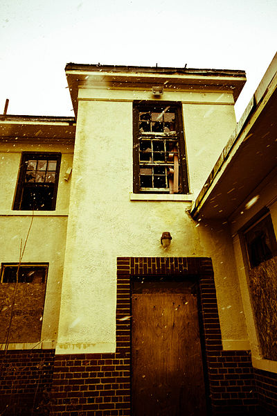 Boarded doors and windows in an attempt to prevent vandals from entering. Author: Shezamm CC BY-SA 2.0