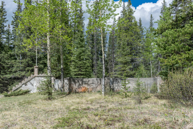 This photo shows a building foundation. The building has been removed and a forest has taken over the setting. These remains are left from the abandoned coal mining town of Bankhead located in Banff National Park, Canada.