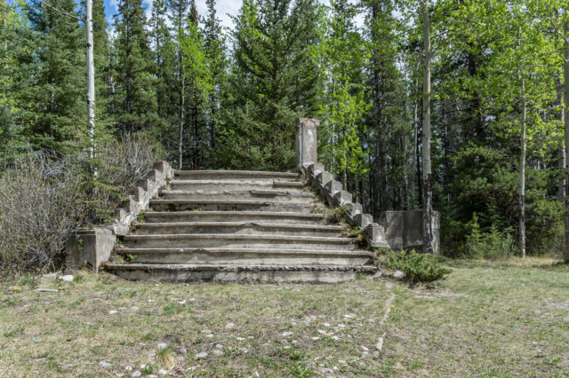 This photo shows a building foundation. The building has been removed and a forest has taken over the setting. These remains are left from the abandoned coal mining town of Bankhead located in Banff National Park, Canada.