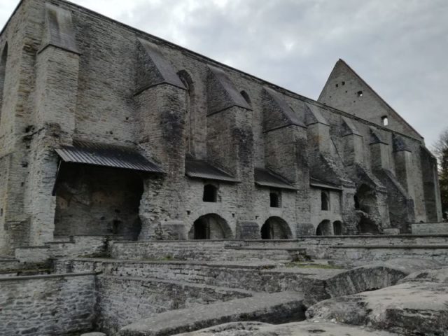 Foundations of several stone buildings next to the imposing Gothic church