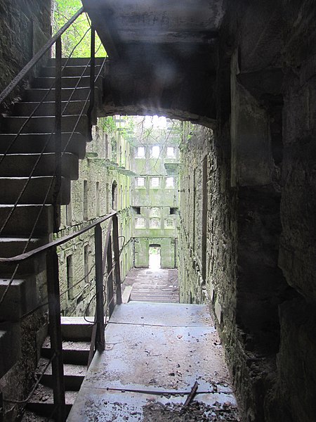 This view, looking from the restored area into an unrestored wing, gives an idea of what state it’s in now. Bodmin Jail, Bodmin, Cornwall, England. Author: Robert Linsdell CC BY 2.0