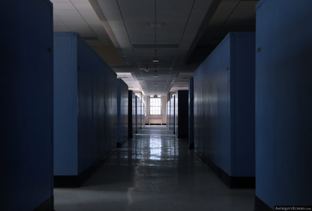 A shadowed hallway with blue walls