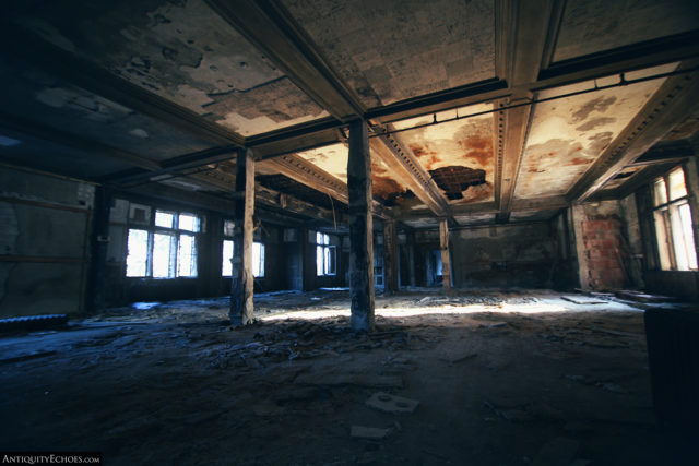 Decaying room with metal beams on the ceiling