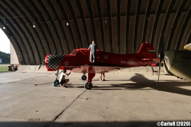Red airplane inside a hangar
