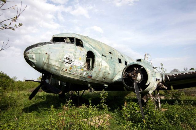 Abandoned Douglas C-47 airplane in the grass
