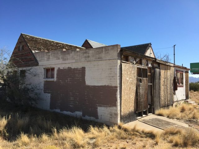 Boarded up cement building