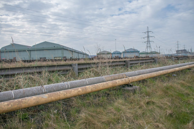 Metal pipelines with buildings in the background