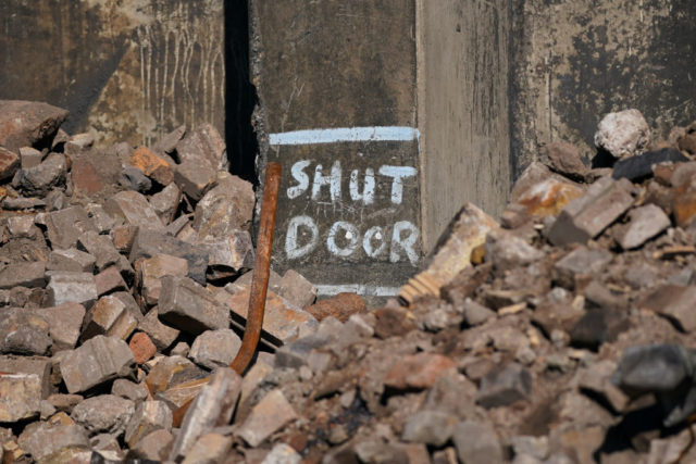 "Shut Door" painted on crumbled concrete at the Dorman Long tower site