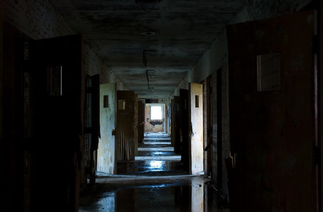 Darkened hallway with open doors