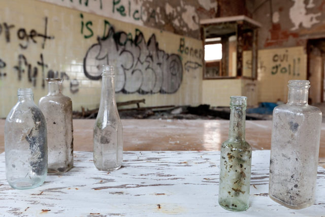 Empty glass bottles atop a table