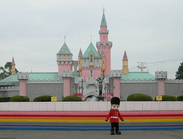 Statue of the Queen's guard standing in front of a pink castle