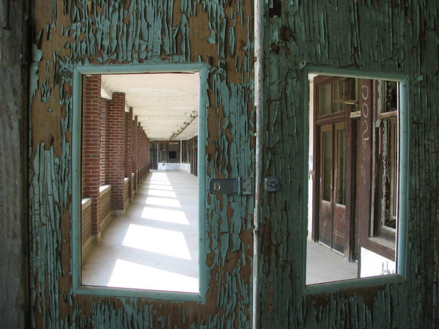 Looking into a hallway via windows in two doors
