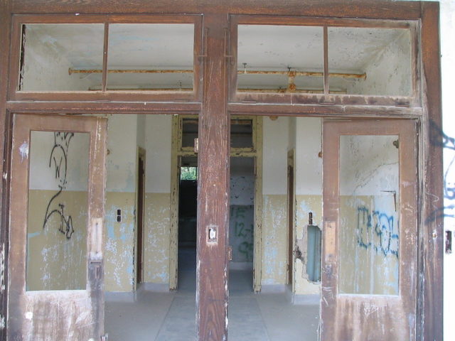 Two open doors leading into the Waverly Hills Sanatorium