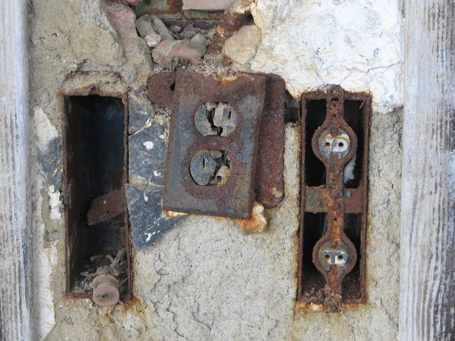 Rusty electrical plugs in the wall