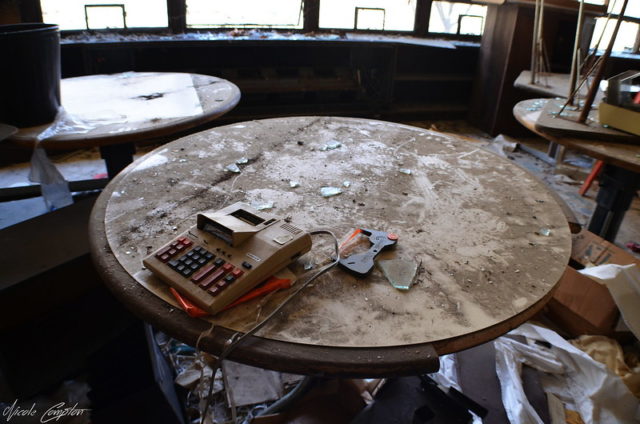 Old calculator atop a circular wooden table