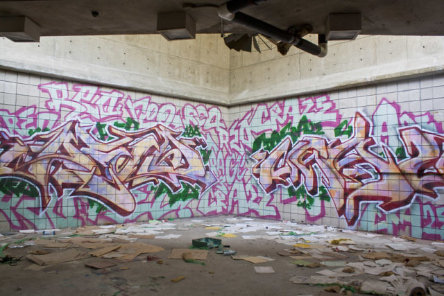 Graffiti-covered tiled wall