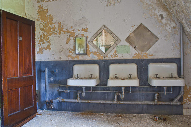 Three bathroom sink along a wall