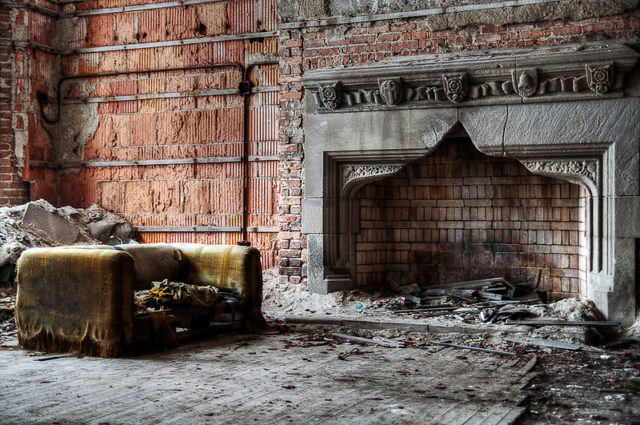 Charred sofa and fireplace