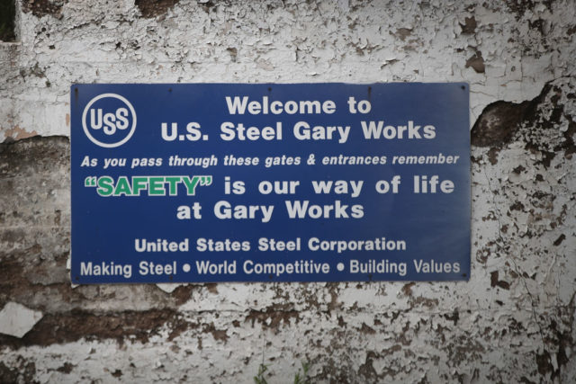 United States Steel Corporation sign against a wall with flaking white paint