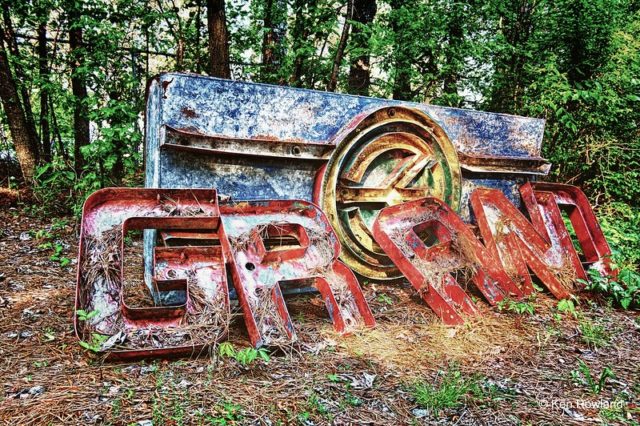 Broken, rusty sign in the forest
