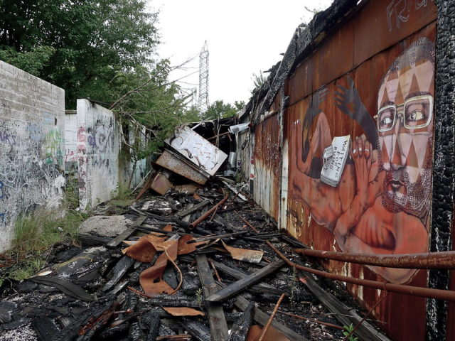 Debris between a concrete wall and a building