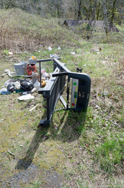 Overturned chair and trash in the grass