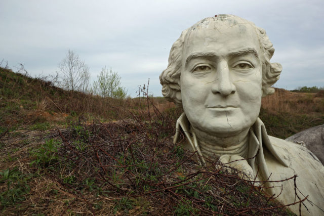 Bust from Presidents Park surrounded by a mountain of soil