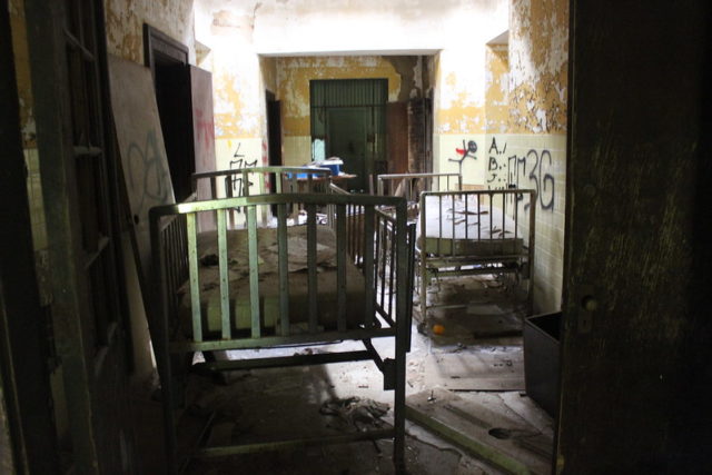Cribs in a darkened hallway