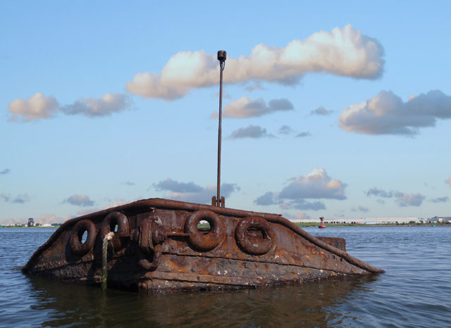 Tugboat poking out of the water at the Staten Island Tugboat Graveyard