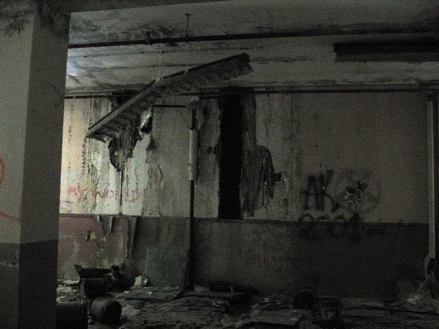 Dark room with peeling paint on the wall