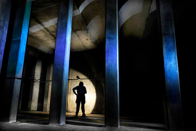 Individual standing in the darkened Dupont Underground