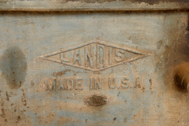 Piece of metal inscribed with "LANDIS MADE IN USA"