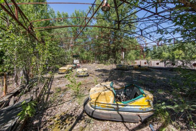 Abandoned amusement park brimming with lush flora. Author: Jonk Photography