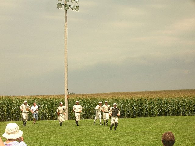 Players running on a baseball field. 