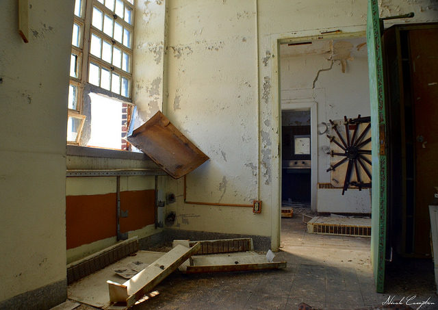 The interior of an abandoned room, debris on the ground.