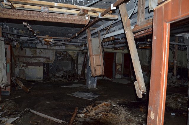 A dark flooded room inside the Buckner Building. Author: FairbanksMike CC BY 2.0