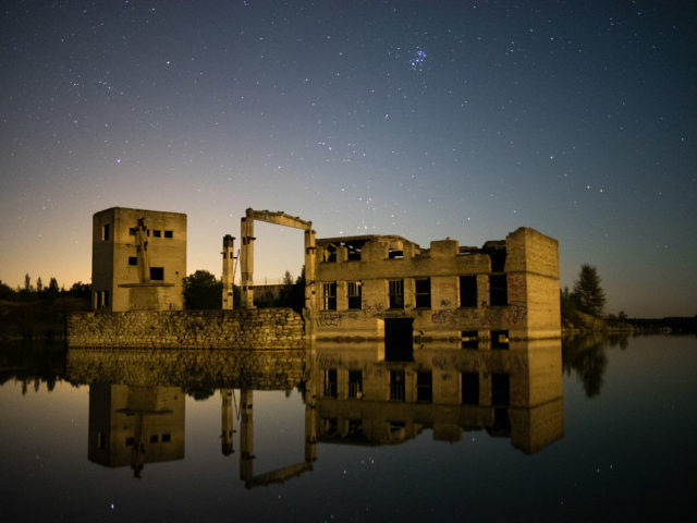 Derelict Rummu quarry utility buildings in the water at night, September 2014. Author: Janno Kusman CC BY-SA 2.0