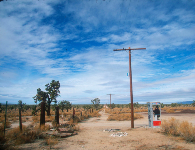 A phone booth in the desert.