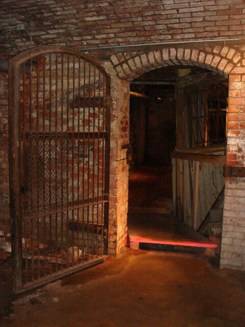 Dimly-lit doorway with its gated door open