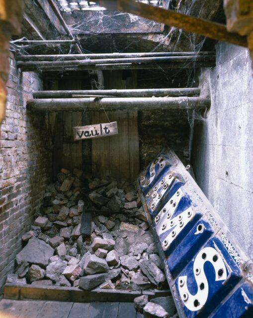 Store sign covered in pieces of rubble