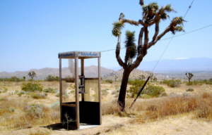 A phone booth in the desert.